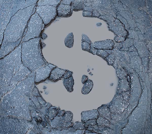 A dollar-sign-shaped pothole