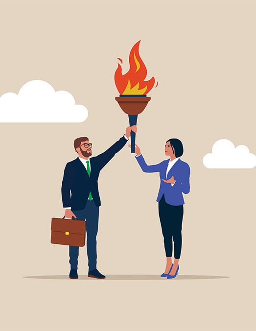 A man and woman holding up a torch